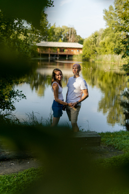 man and woman by lake distant